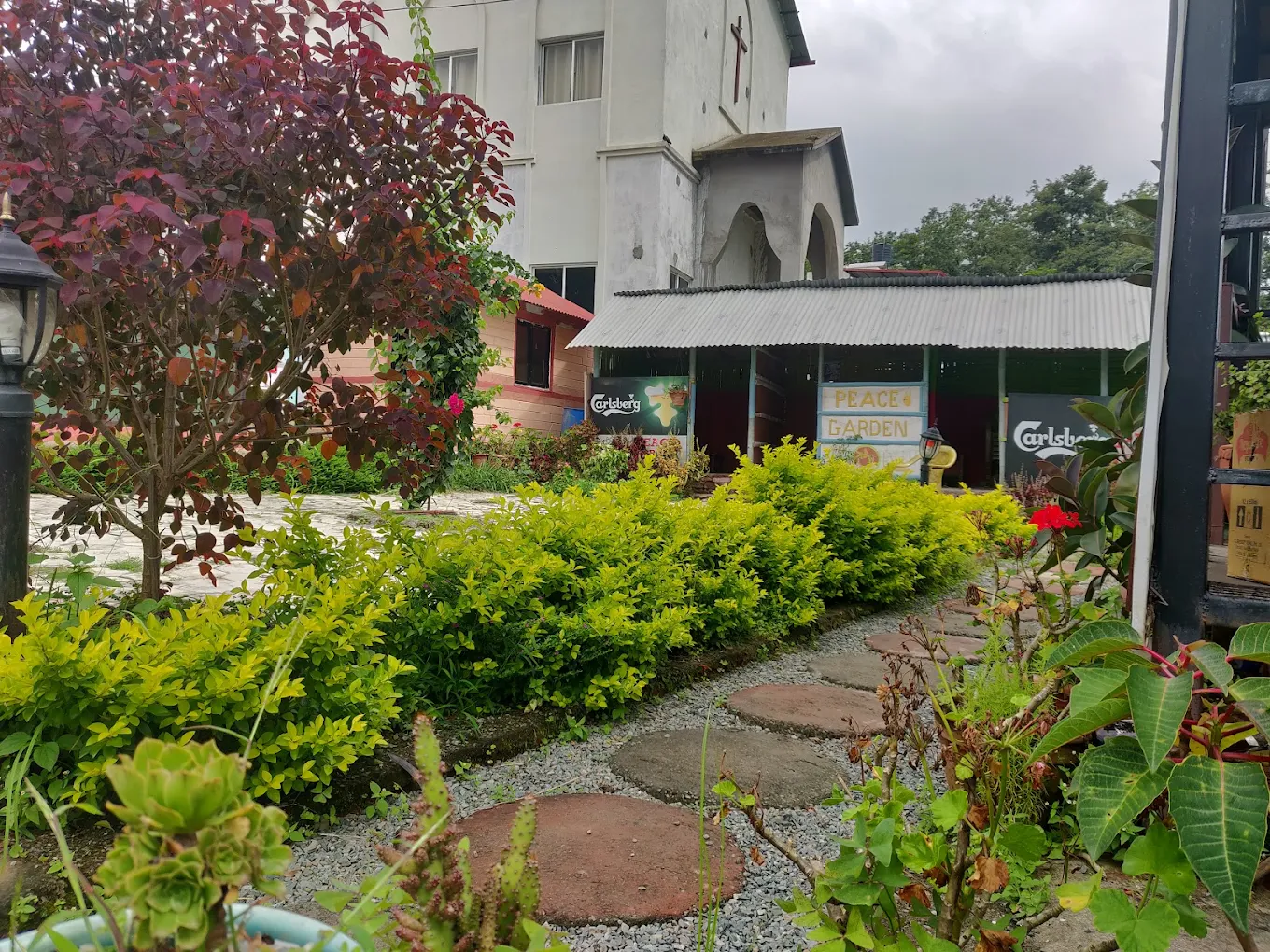 Green garden path with Peace Garden sign visible in Thecho Lalitpur